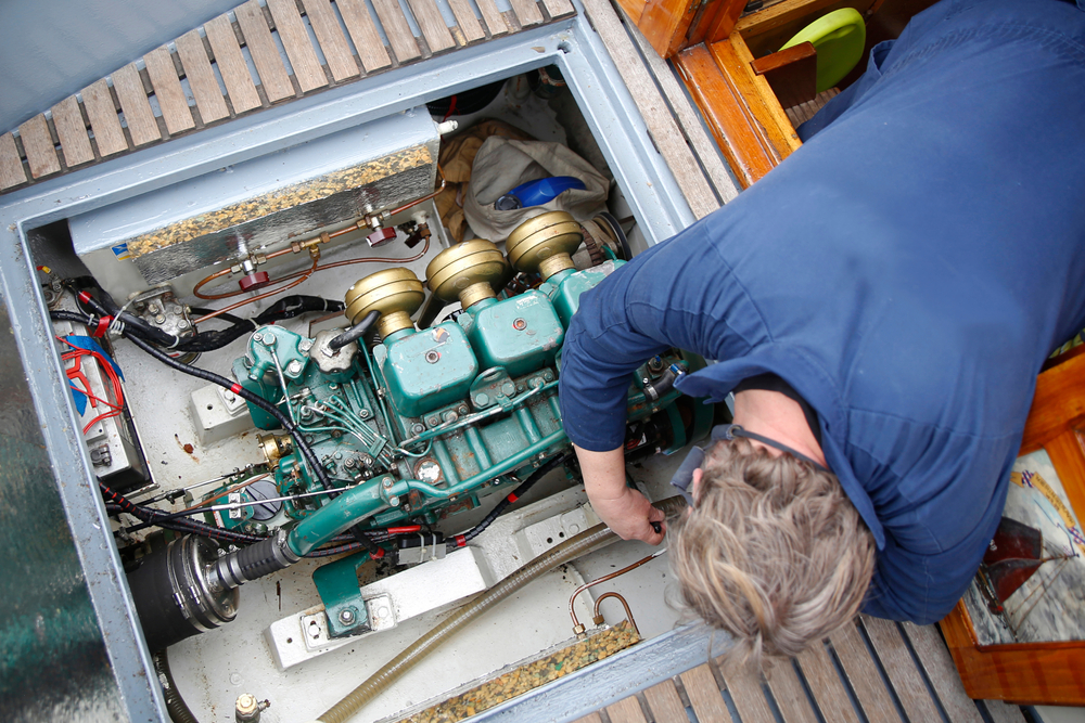 a,service,engineer,fixing,the,engine,of,a,vessel