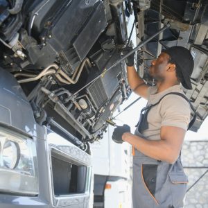 mechanic under the hood of a diesel truck