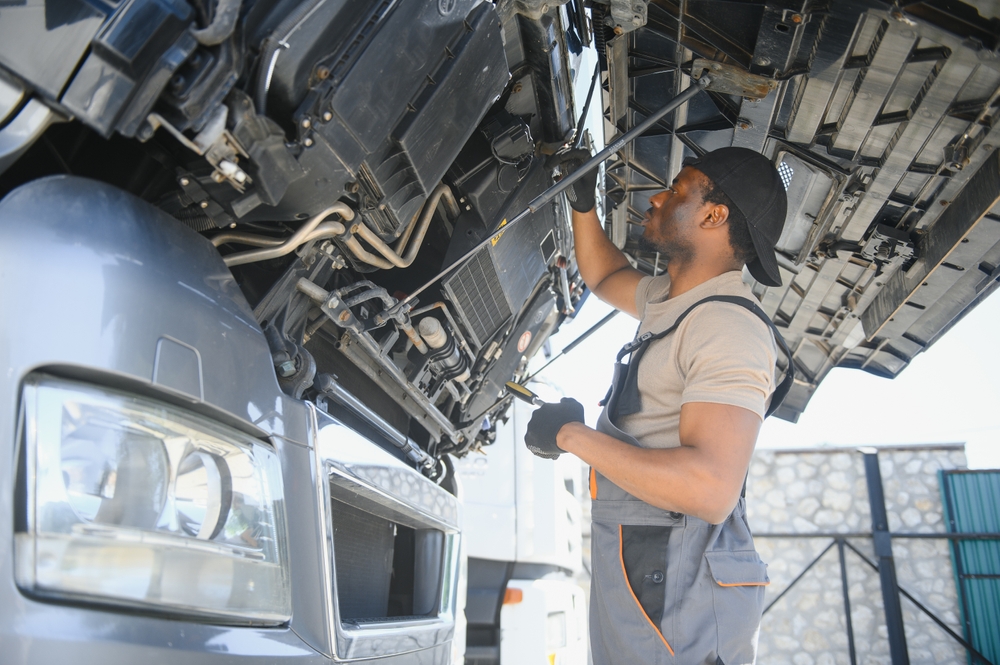 mechanic under the hood of a diesel truck