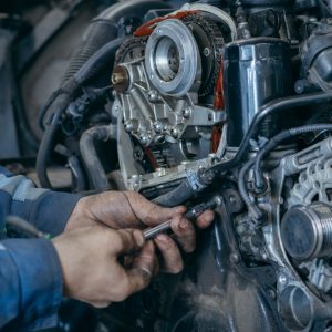 auto,mechanic,repairs,an,engine.,replacing,the,timing,chain