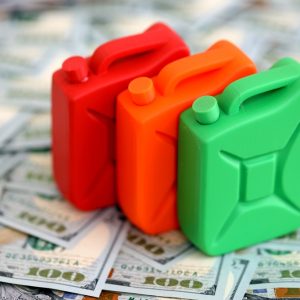 gasoline,canister,lies,on,big,amount,of,dollar,bills.,concept