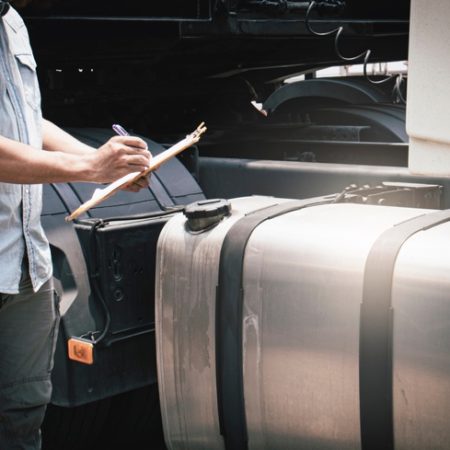 mechanic standing near external fuel tank
